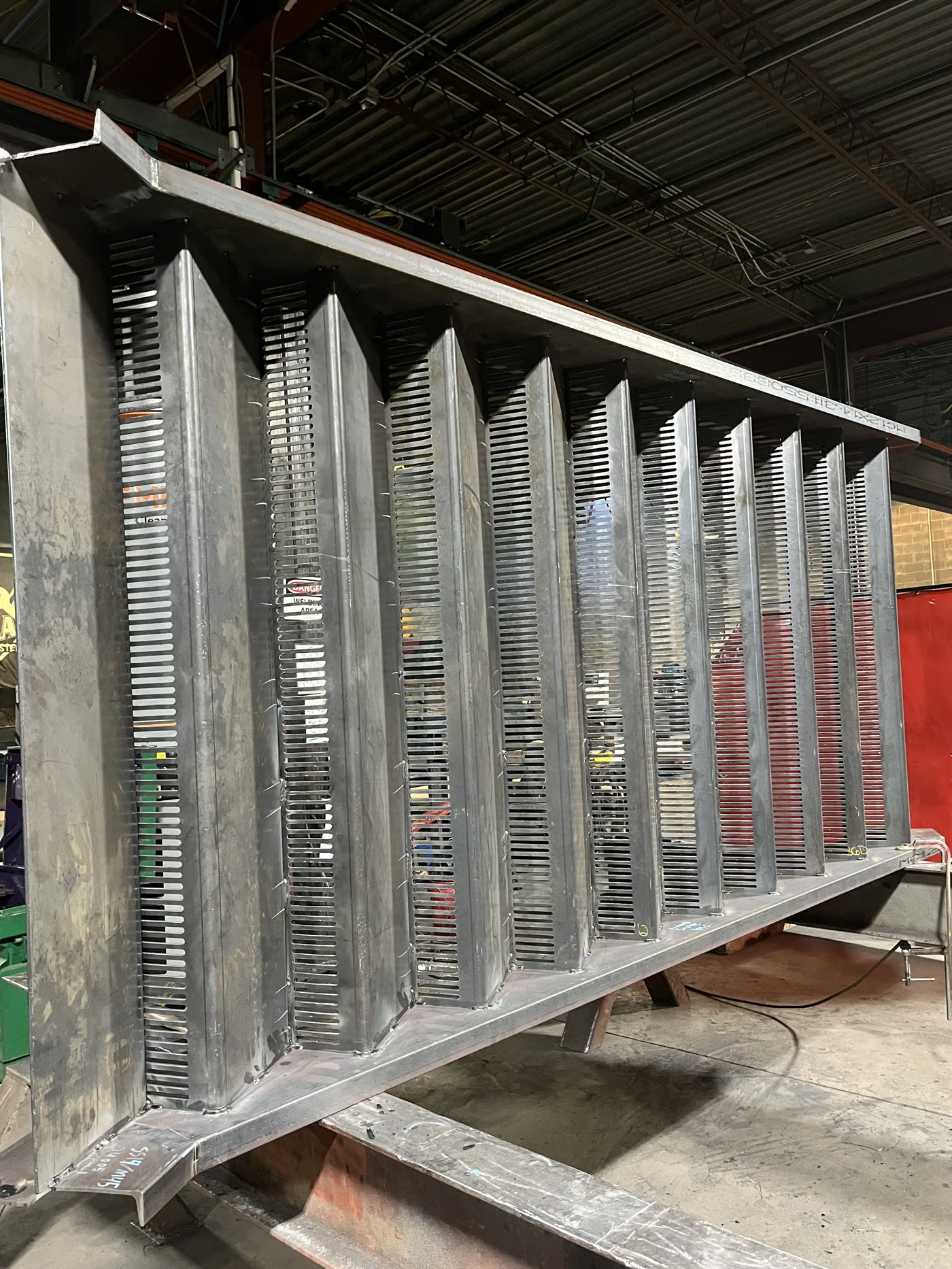 Fabricated miscellaneous steel weldment staged inside the FSW shop.