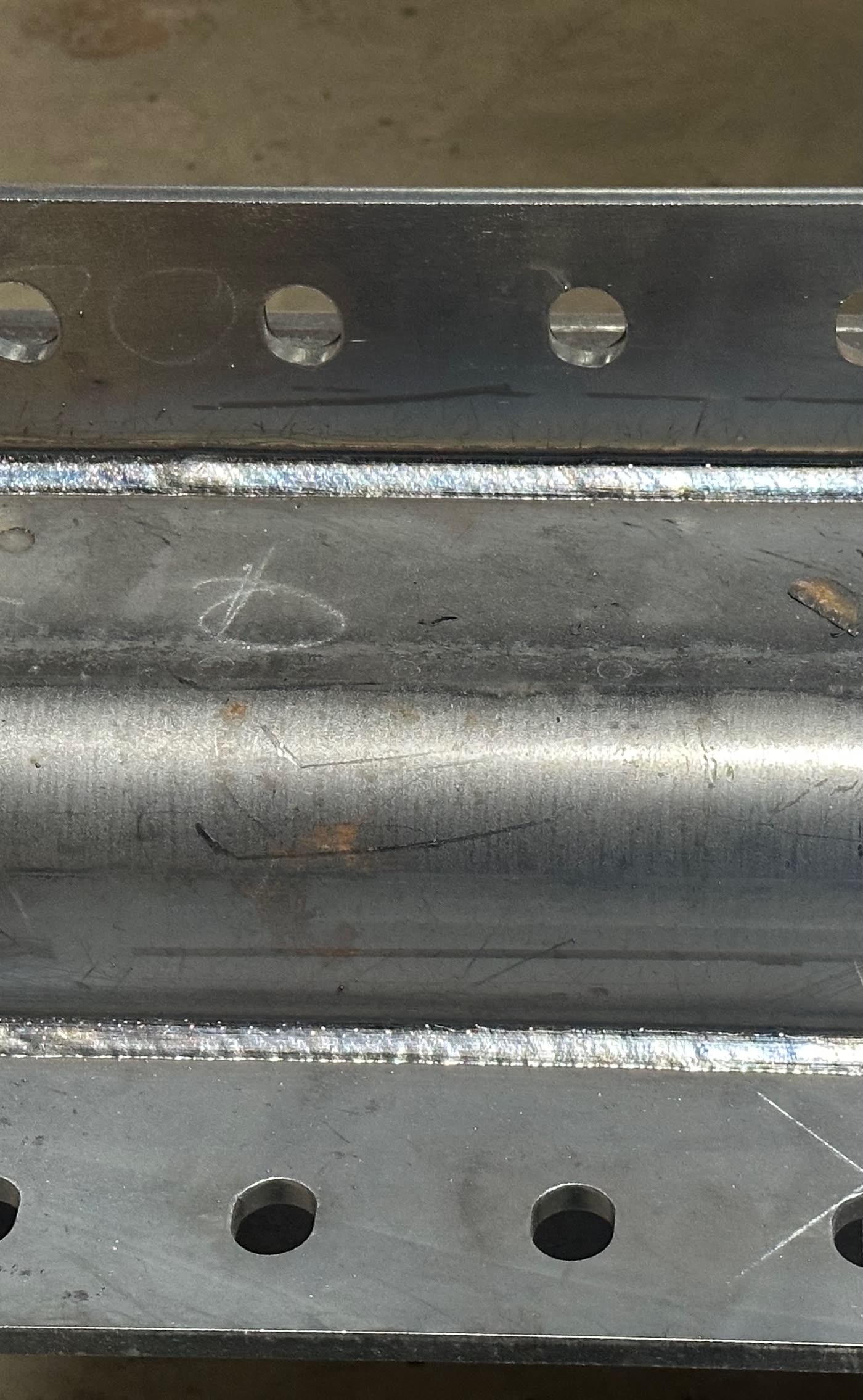 Close-up of a finished fillet weld joining a clip angle to structural steel.